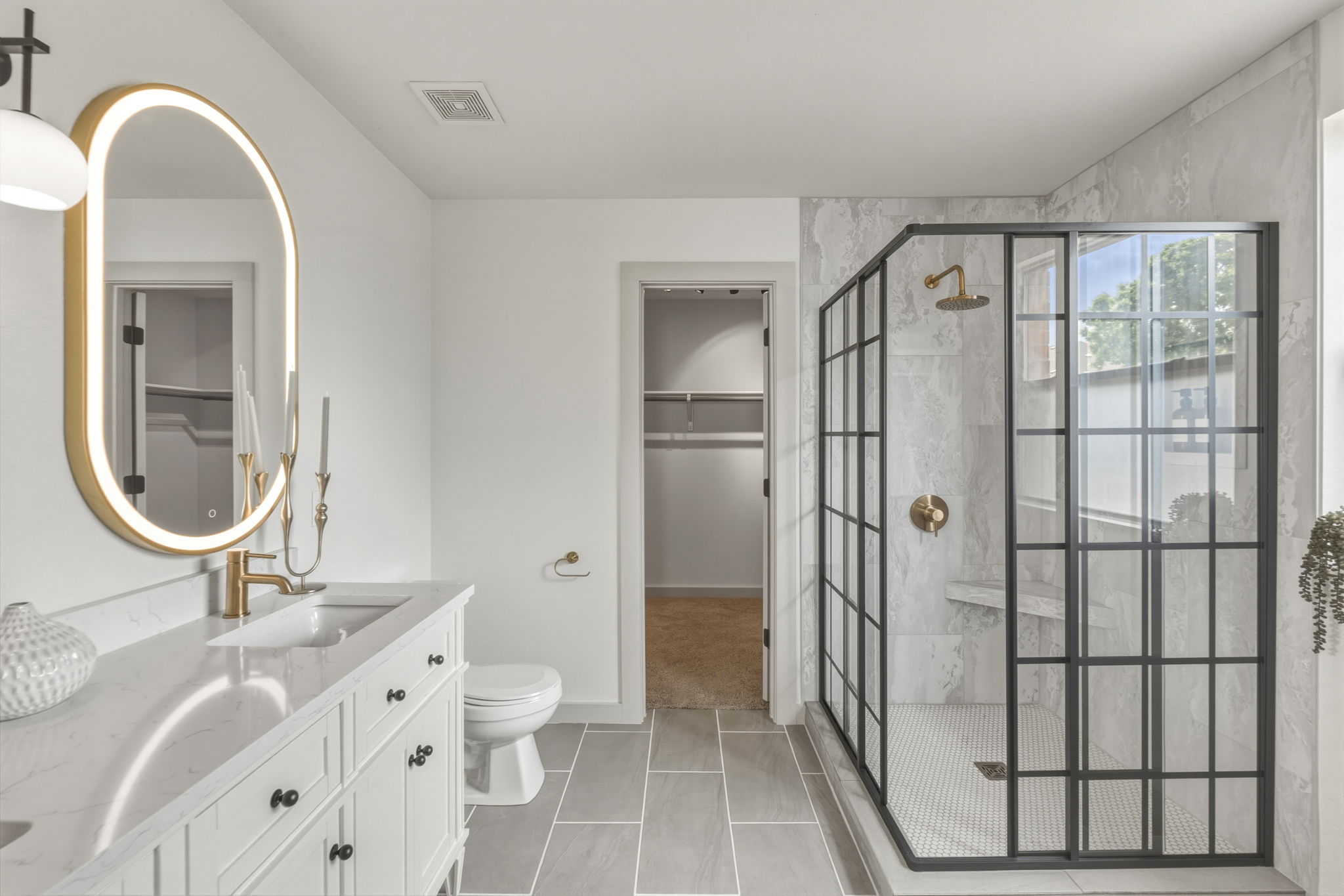 211 Banner Avenue Leander, TX 78641 - Photo 11 of 27 a bathroom with a double vanity sink a toilet and a mirror