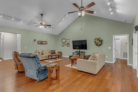 a view of a dining room with furniture and wooden floor