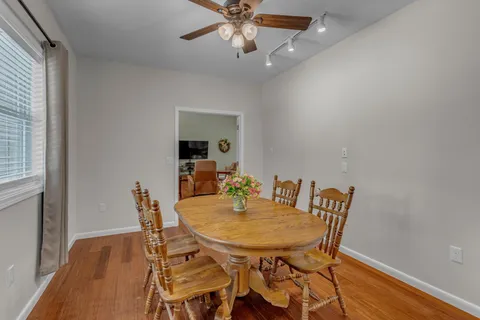a kitchen with white cabinets and refrigerator