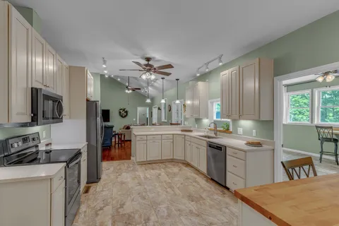 a view of a hallway view with wooden floor and closet