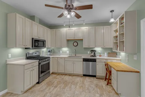 a bedroom with a bed and a flat tv screen on dresser