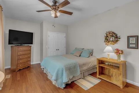 a bathroom with a sink a toilet a mirror and shower