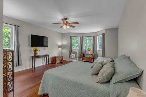 a bedroom with a bed and a chandelier