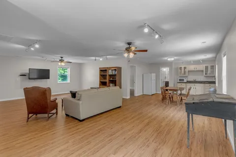 an aerial view of residential house with outdoor space and trees all around