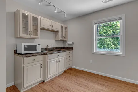 a front view of a house with a garden