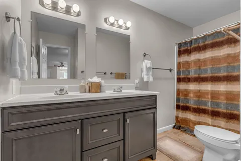 a view of a field with trees in the background