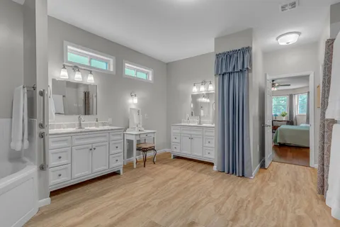 an aerial view of a houses with a lush green hillside