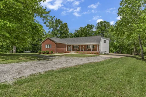 a living room with furniture a rug and a flat screen tv