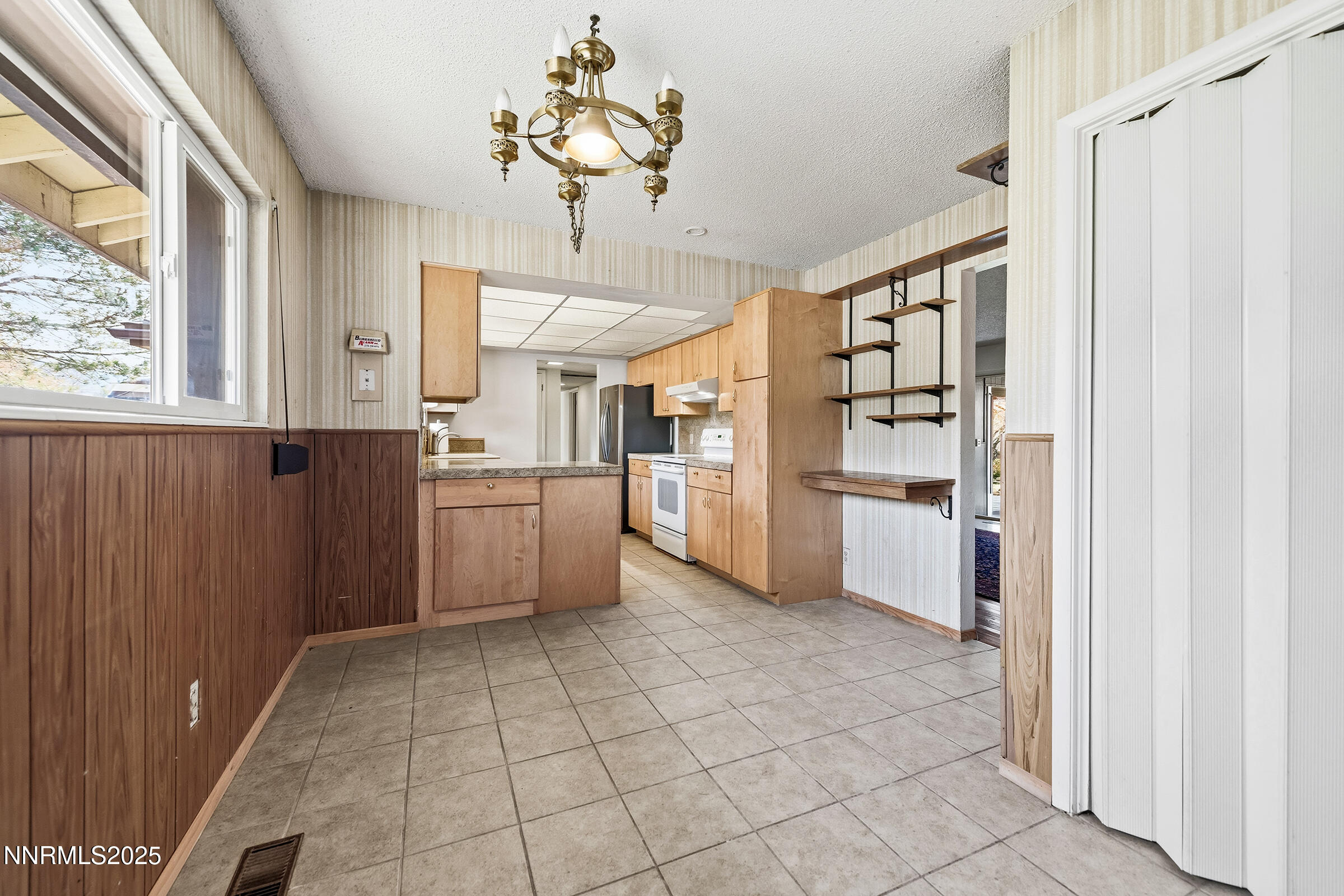 14535 Seminole Trail Reno, NV 89521 - Photo 7 of 25 a kitchen with stainless steel appliances a refrigerator and a stove top oven