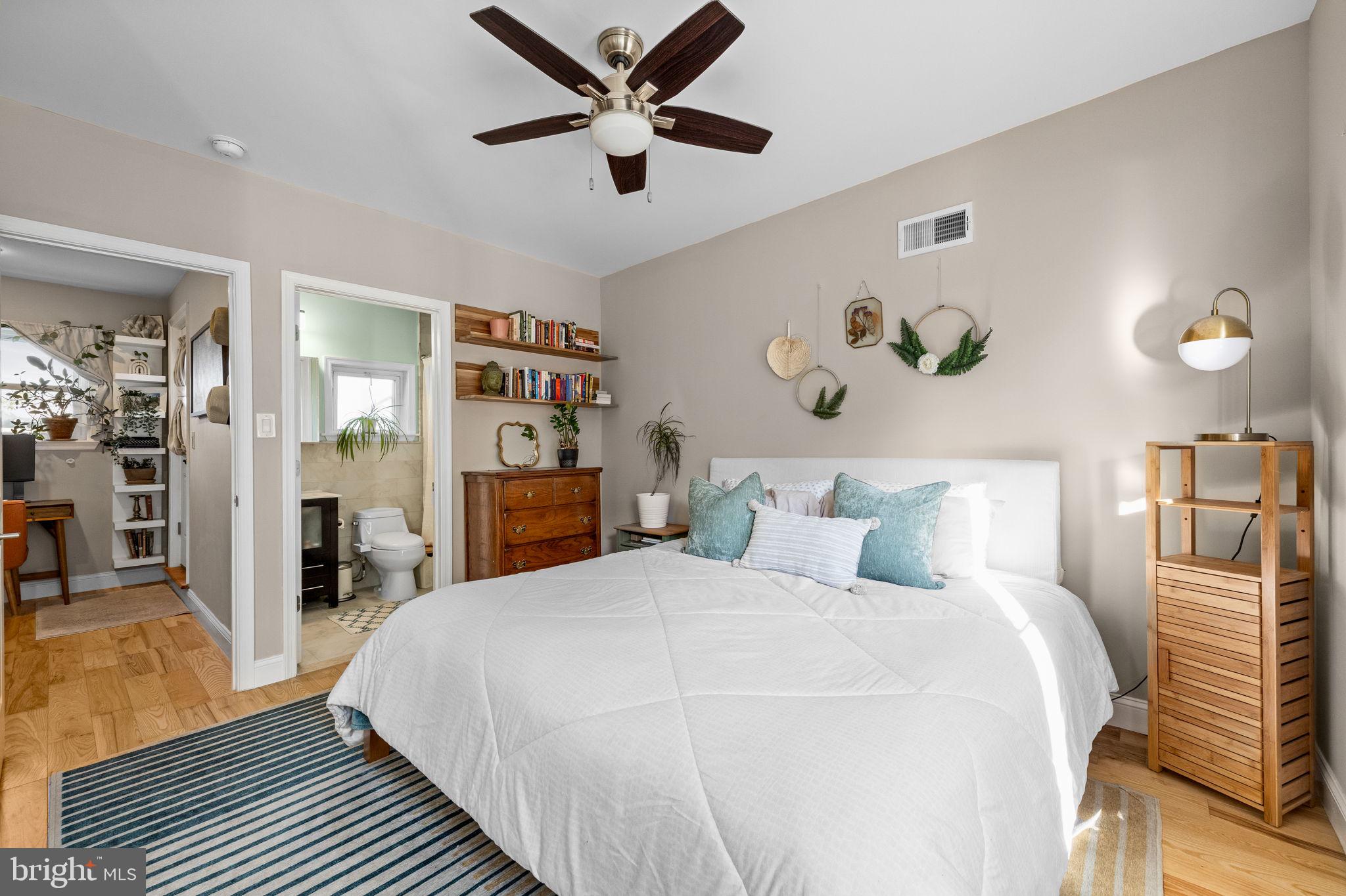 623 Manton Street Philadelphia, PA 19147 - Photo 16 of 26 a bedroom with a large bed and a chandelier