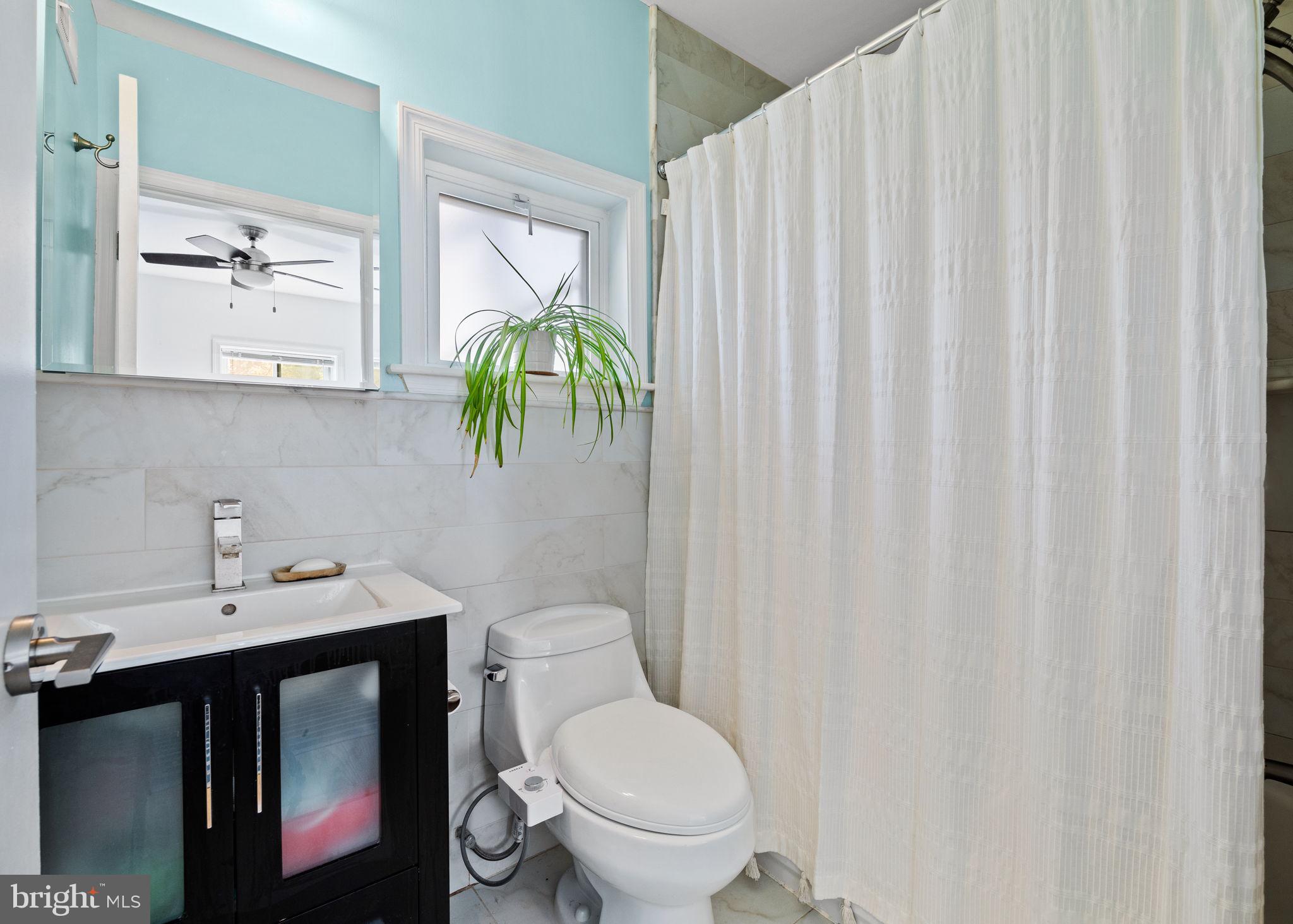 623 Manton Street Philadelphia, PA 19147 - Photo 18 of 26 a bathroom with a toilet sink and mirror
