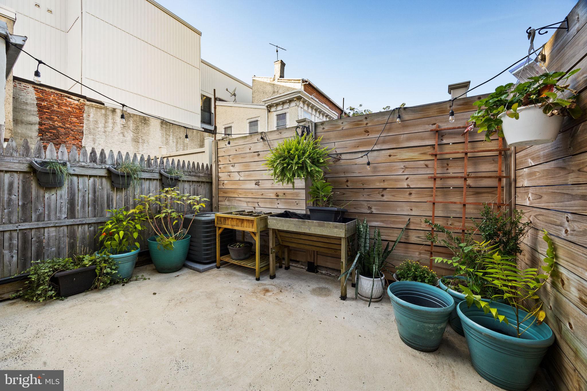 623 Manton Street Philadelphia, PA 19147 - Photo 10 of 26 a backyard of a house with outdoor seating and plants