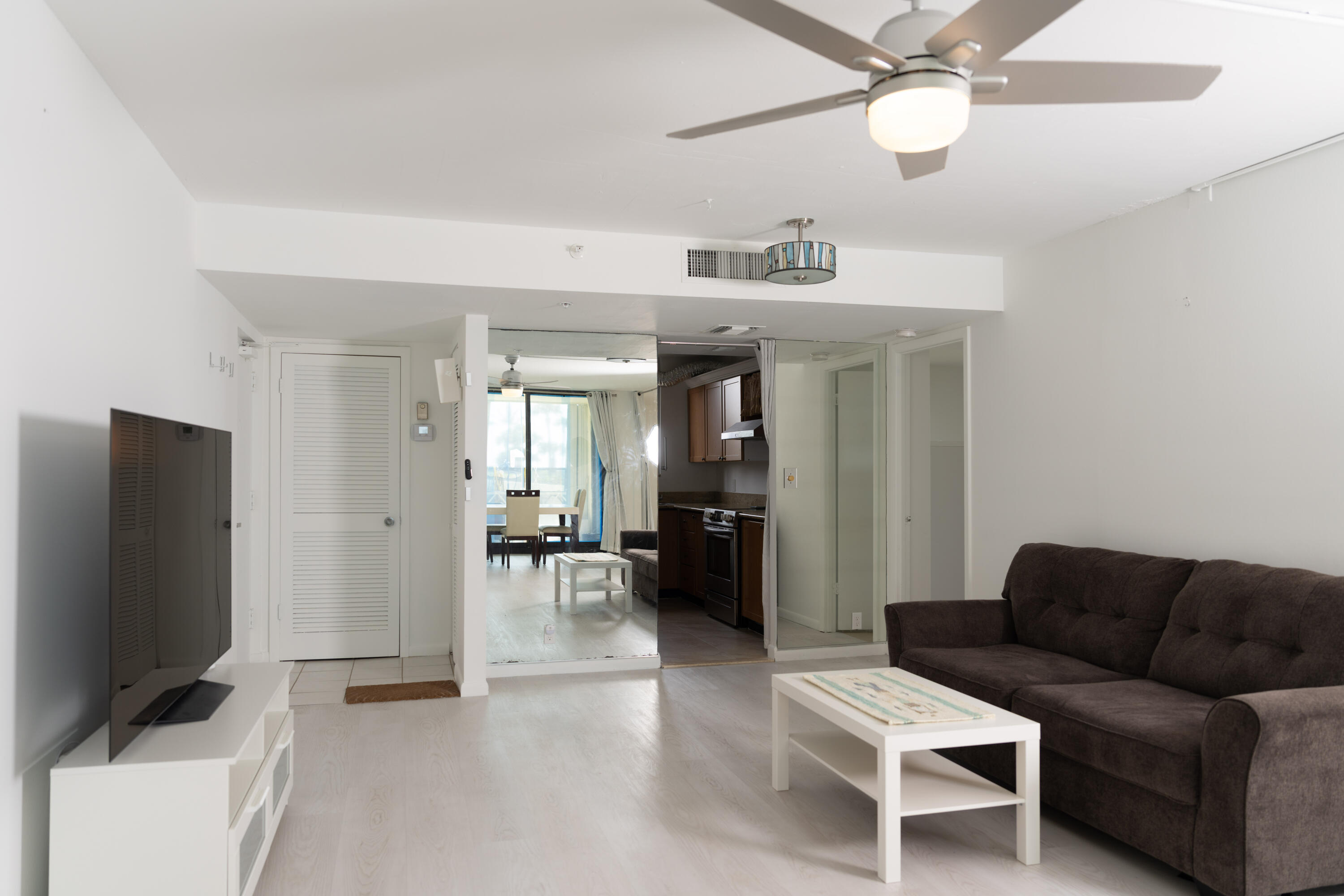 400 Ocean Trail Way, Unit 101 Jupiter, FL 33477 - Photo 16 of 60 a living room with furniture and a flat screen tv