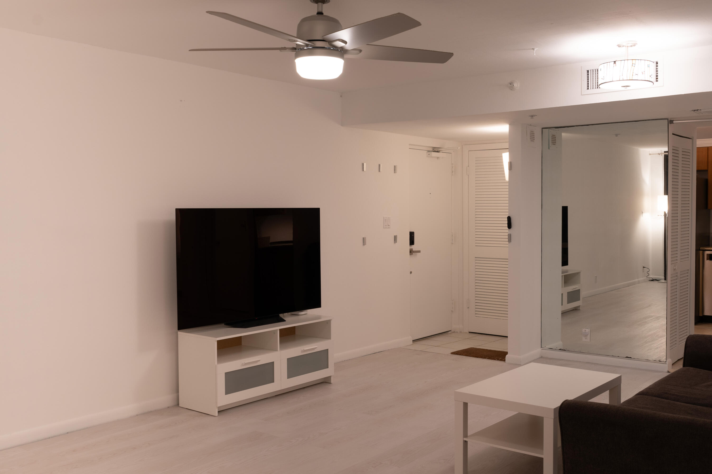 400 Ocean Trail Way, Unit 101 Jupiter, FL 33477 - Photo 24 of 60 a living room with a flat screen tv and a ceiling fan