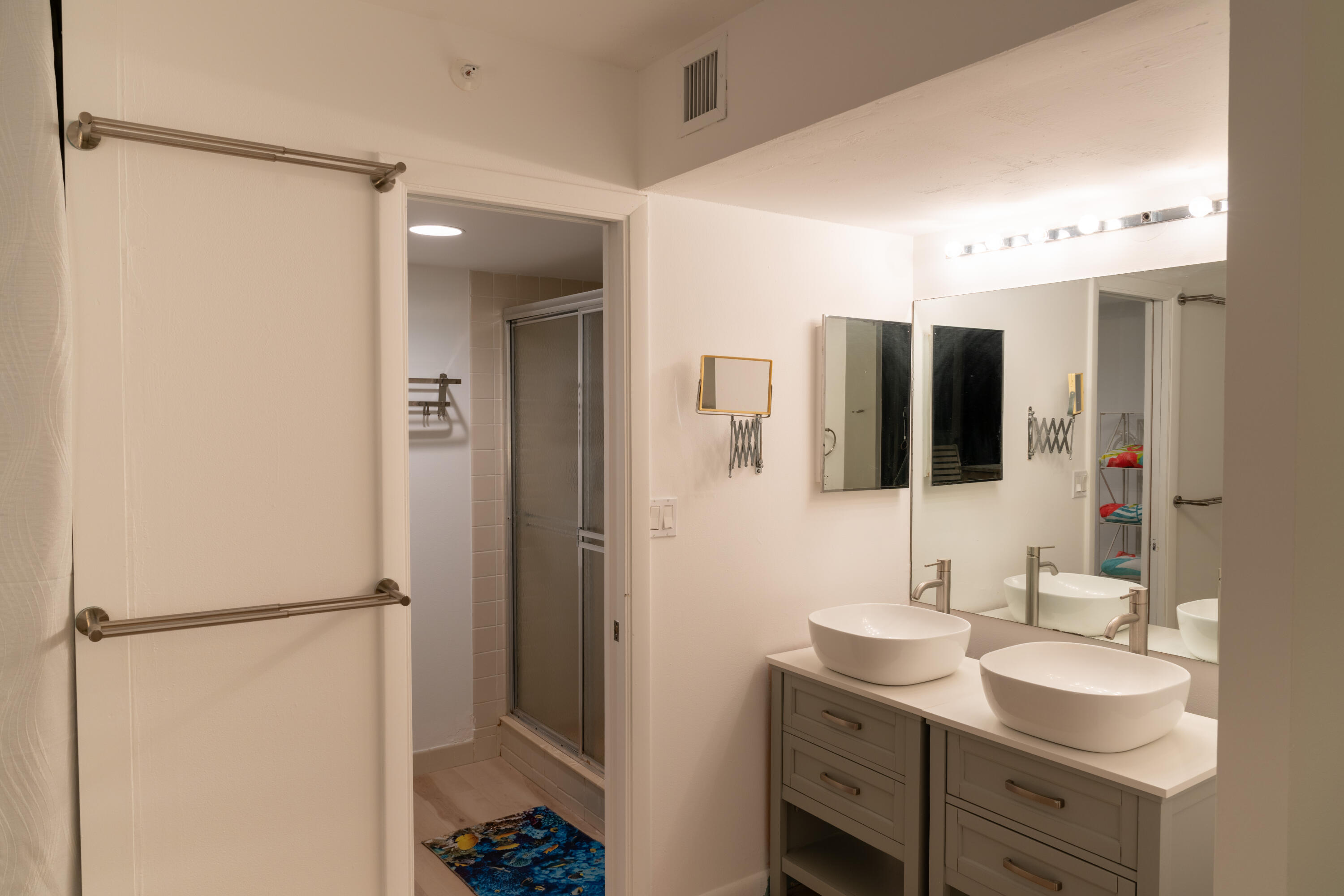 400 Ocean Trail Way, Unit 101 Jupiter, FL 33477 - Photo 26 of 60 a bathroom with a double vanity sink and mirror