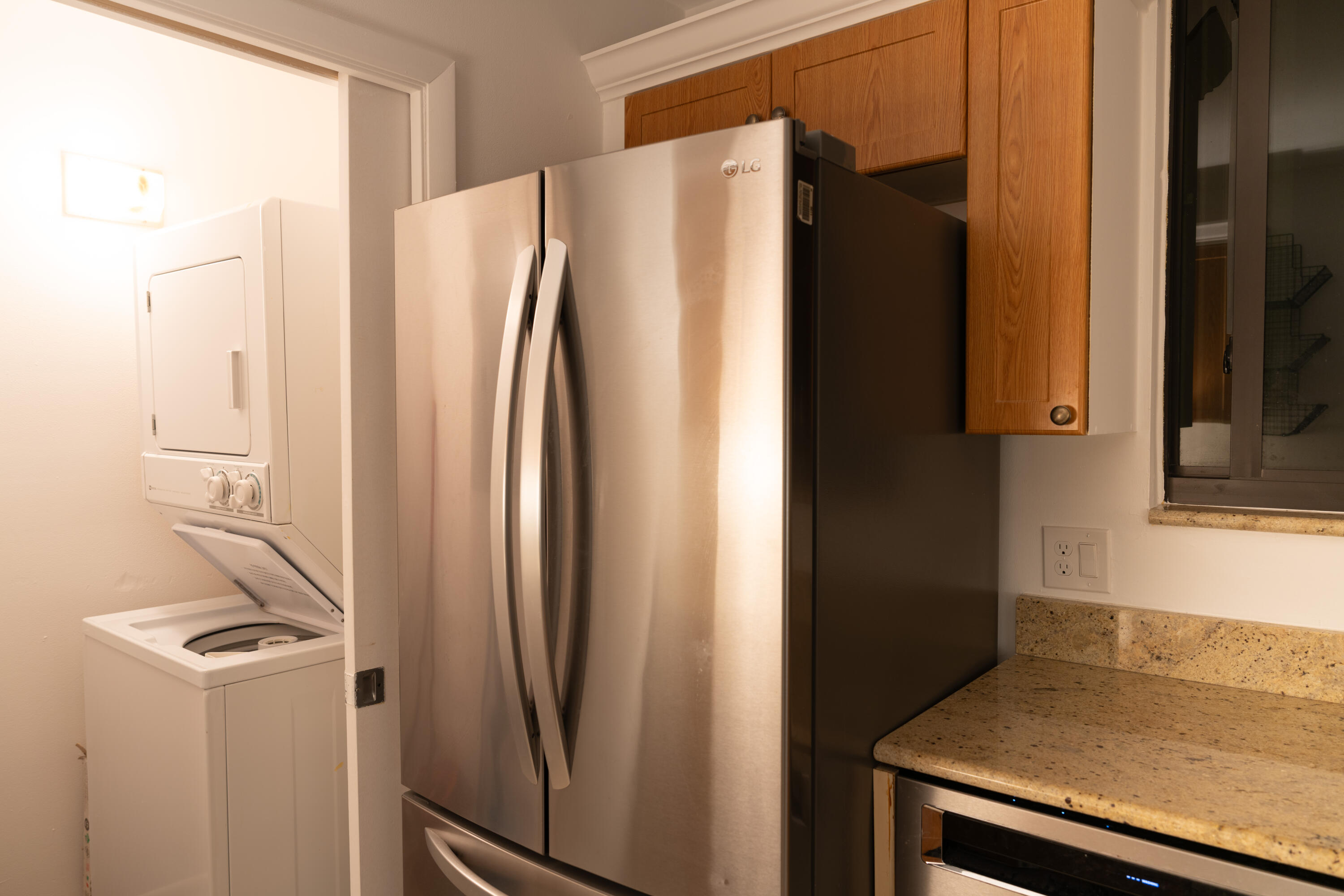 400 Ocean Trail Way, Unit 101 Jupiter, FL 33477 - Photo 29 of 60 a metallic refrigerator freezer sitting in a kitchen
