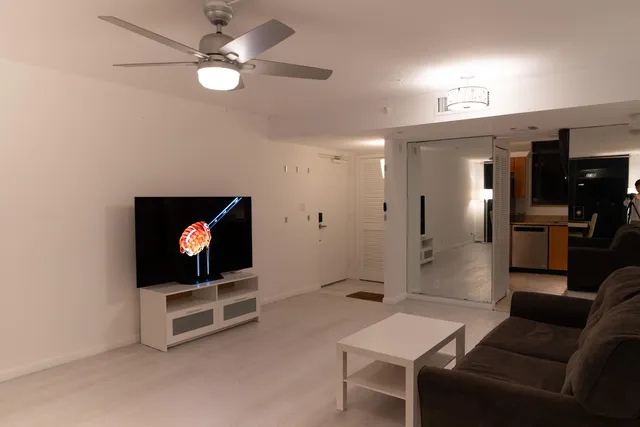 a view of living room kitchen with furniture and stainless steel appliances