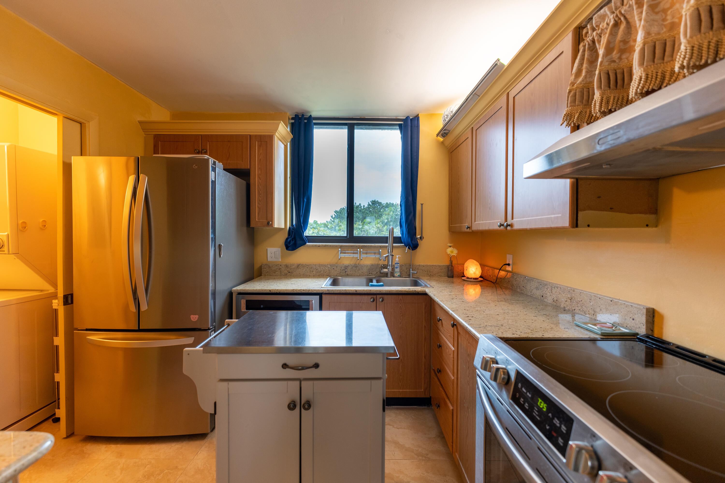 400 Ocean Trail Way, Unit 101 Jupiter, FL 33477 - Photo 41 of 60 a kitchen that has a sink a stove and a refrigerator