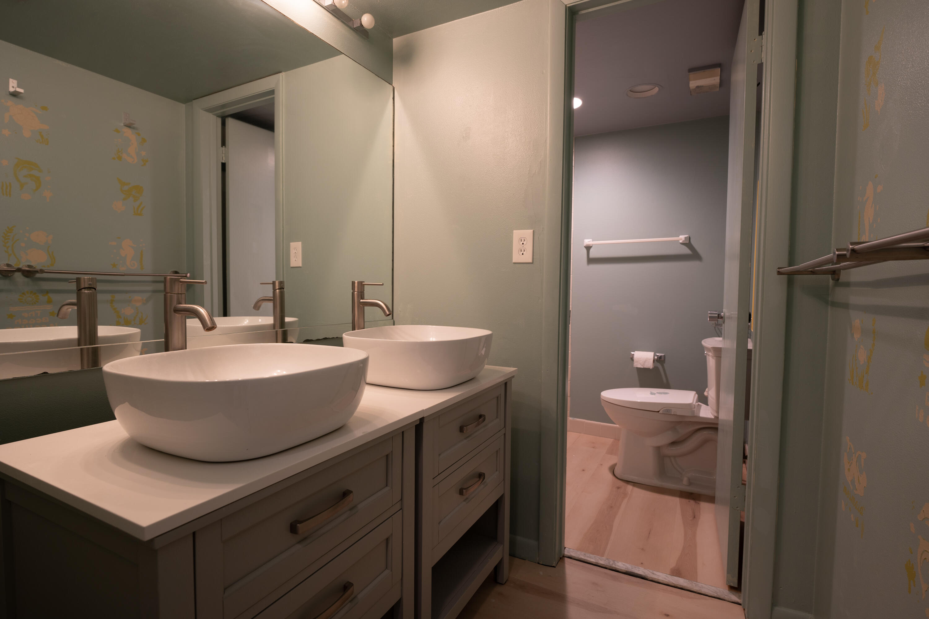 400 Ocean Trail Way, Unit 101 Jupiter, FL 33477 - Photo 44 of 60 a bathroom with a sink a toilet and a large mirror