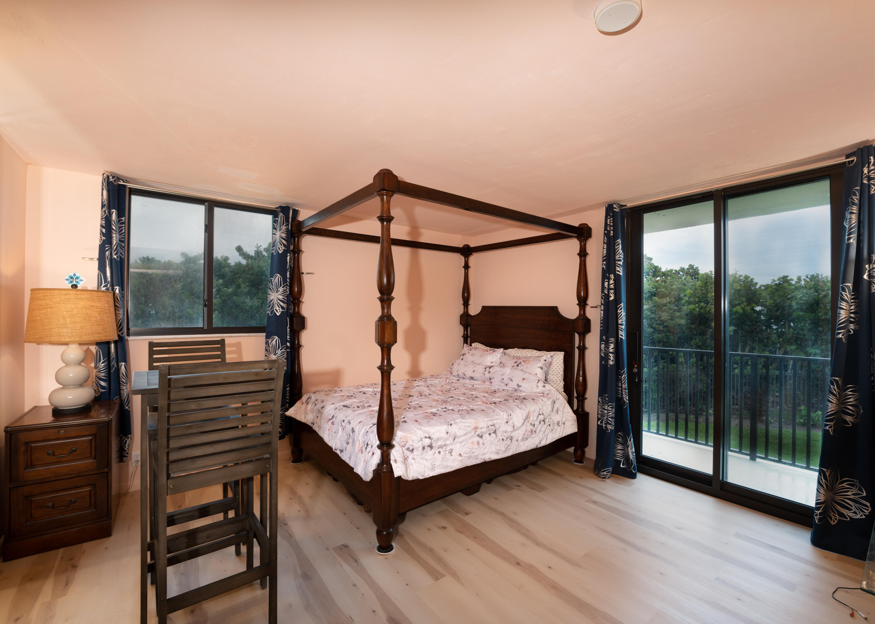 400 Ocean Trail Way, Unit 101 Jupiter, FL 33477 - Photo 52 of 60 a bedroom with a bed and wooden floor