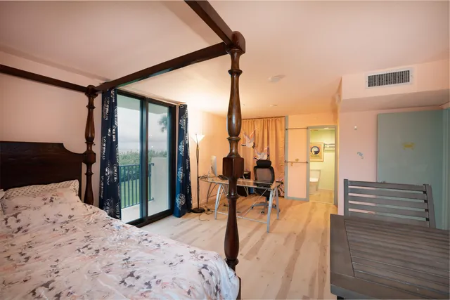 a bedroom with furniture and large windows