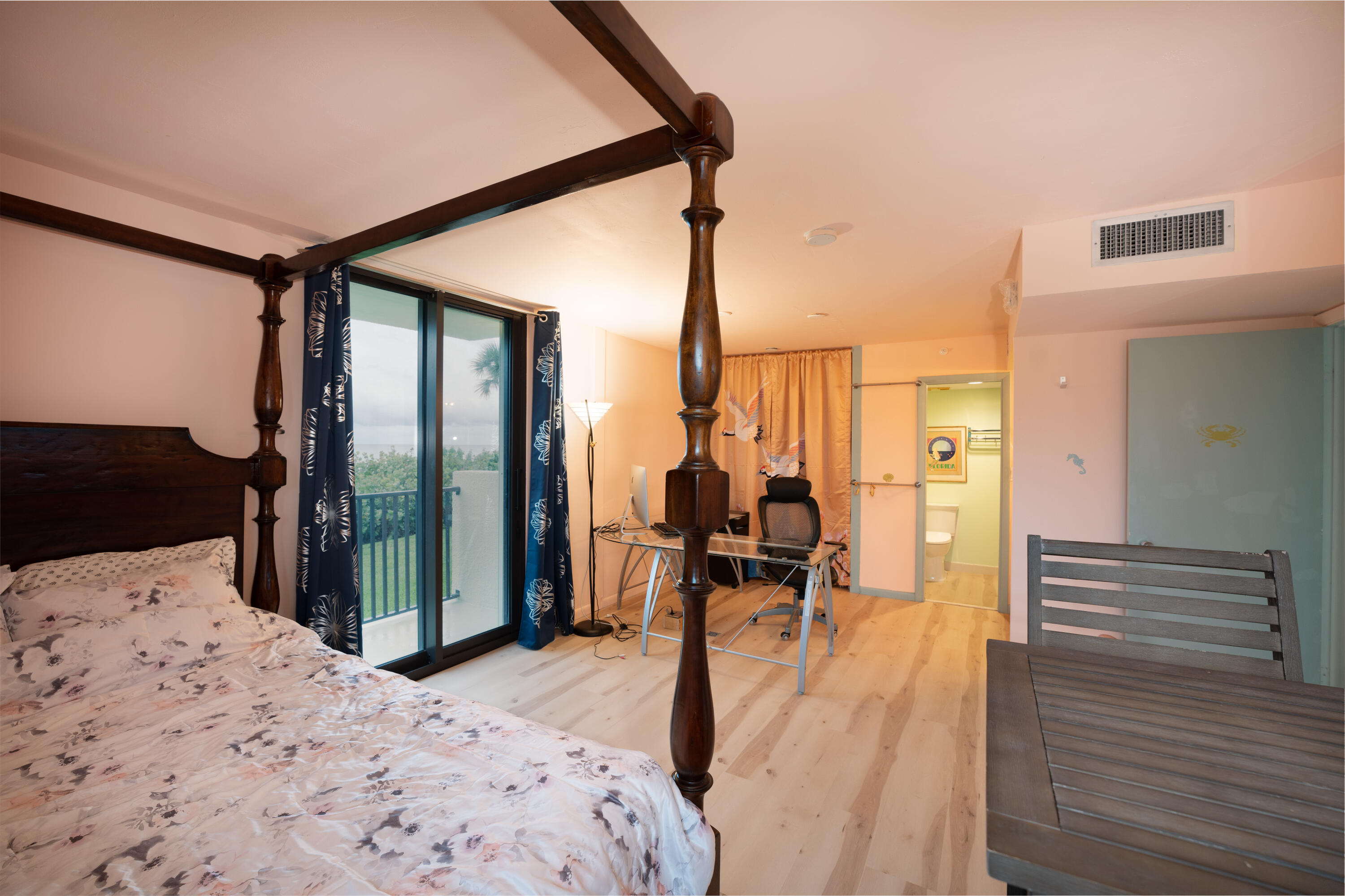 400 Ocean Trail Way, Unit 101 Jupiter, FL 33477 - Photo 53 of 60 a bedroom with a bed and wooden floor