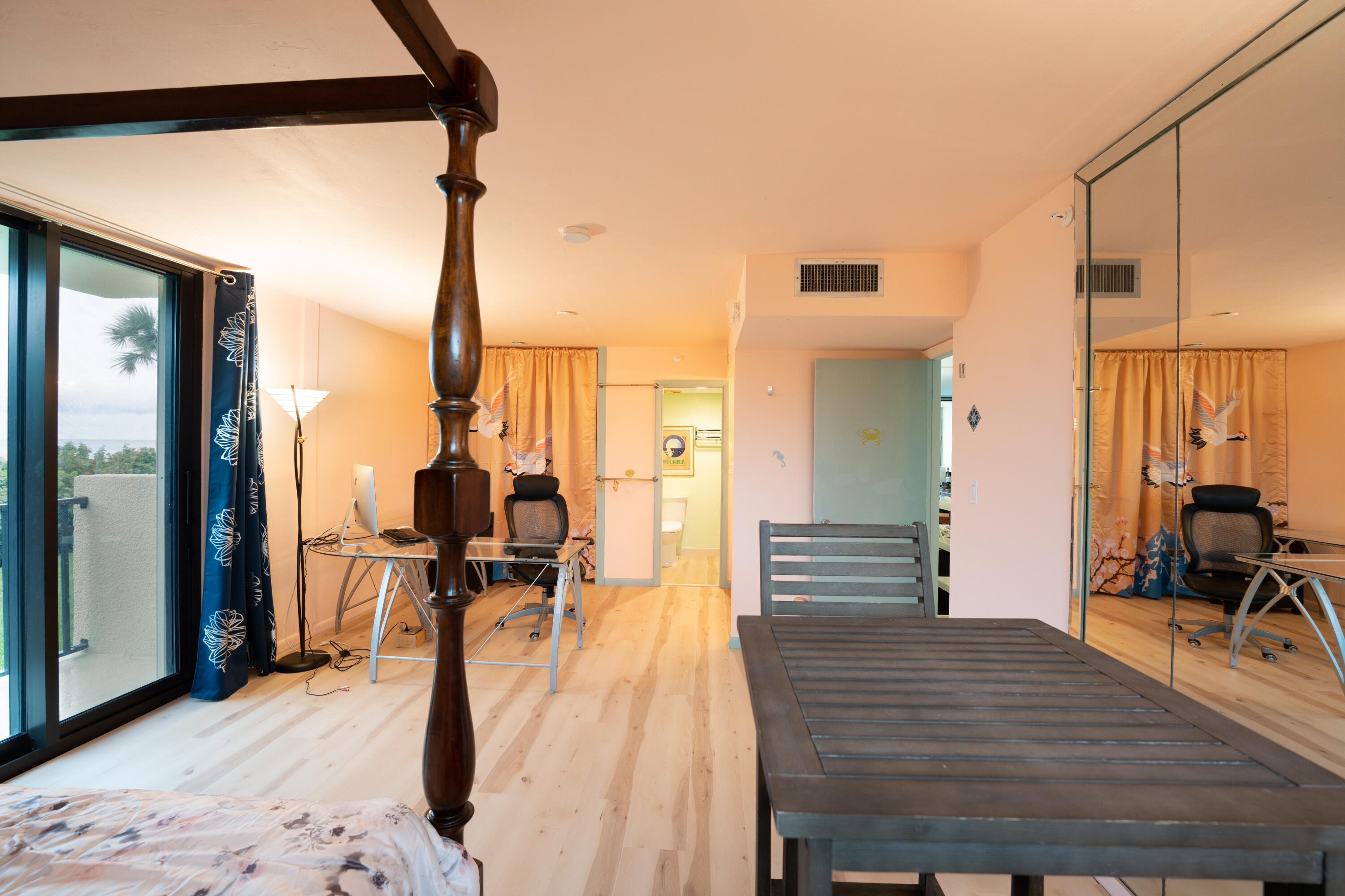 400 Ocean Trail Way, Unit 101 Jupiter, FL 33477 - Photo 55 of 60 a bedroom with a bed and wooden floor