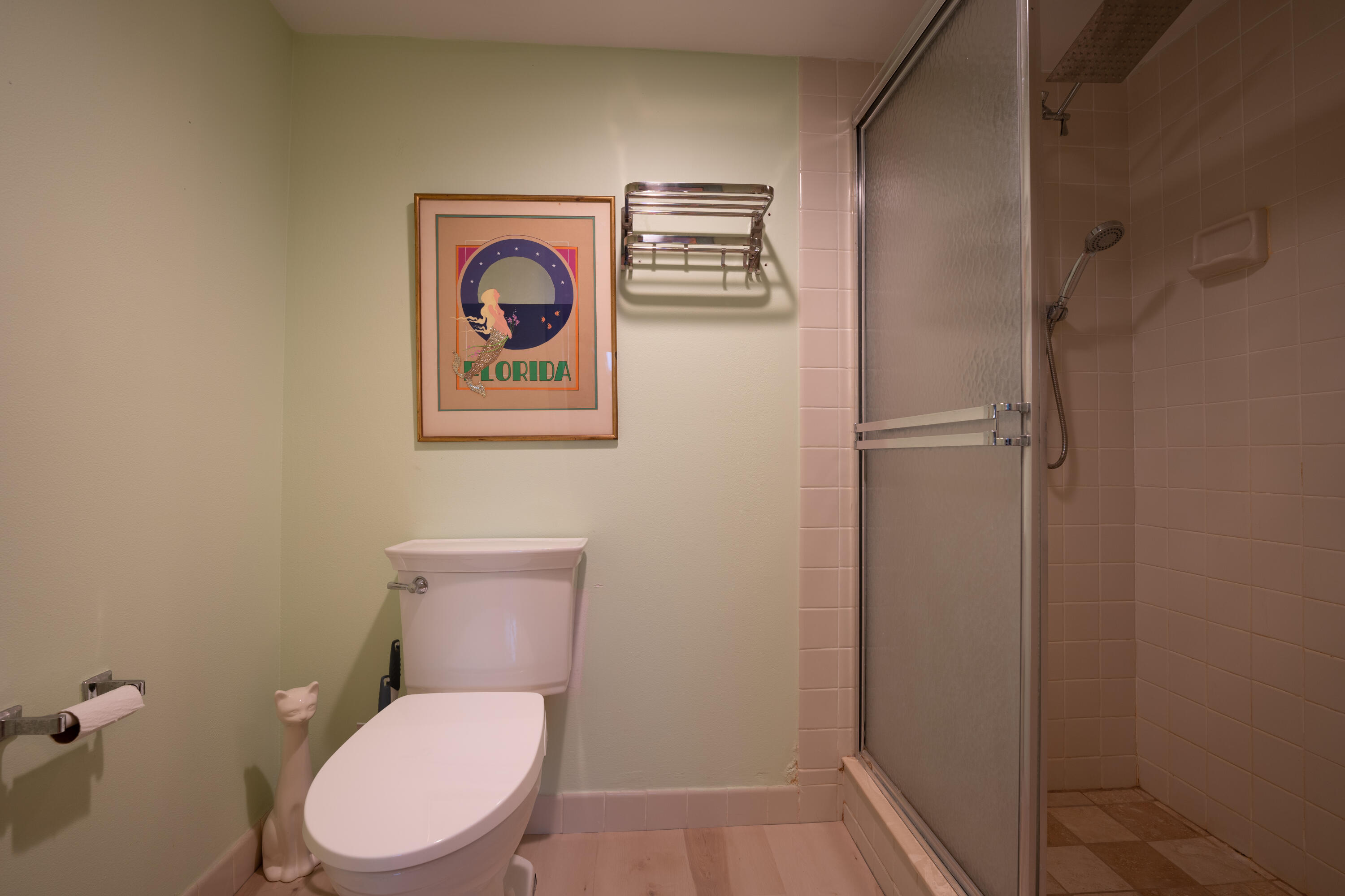 400 Ocean Trail Way, Unit 101 Jupiter, FL 33477 - Photo 57 of 60 a white toilet sitting next to a bathroom sink