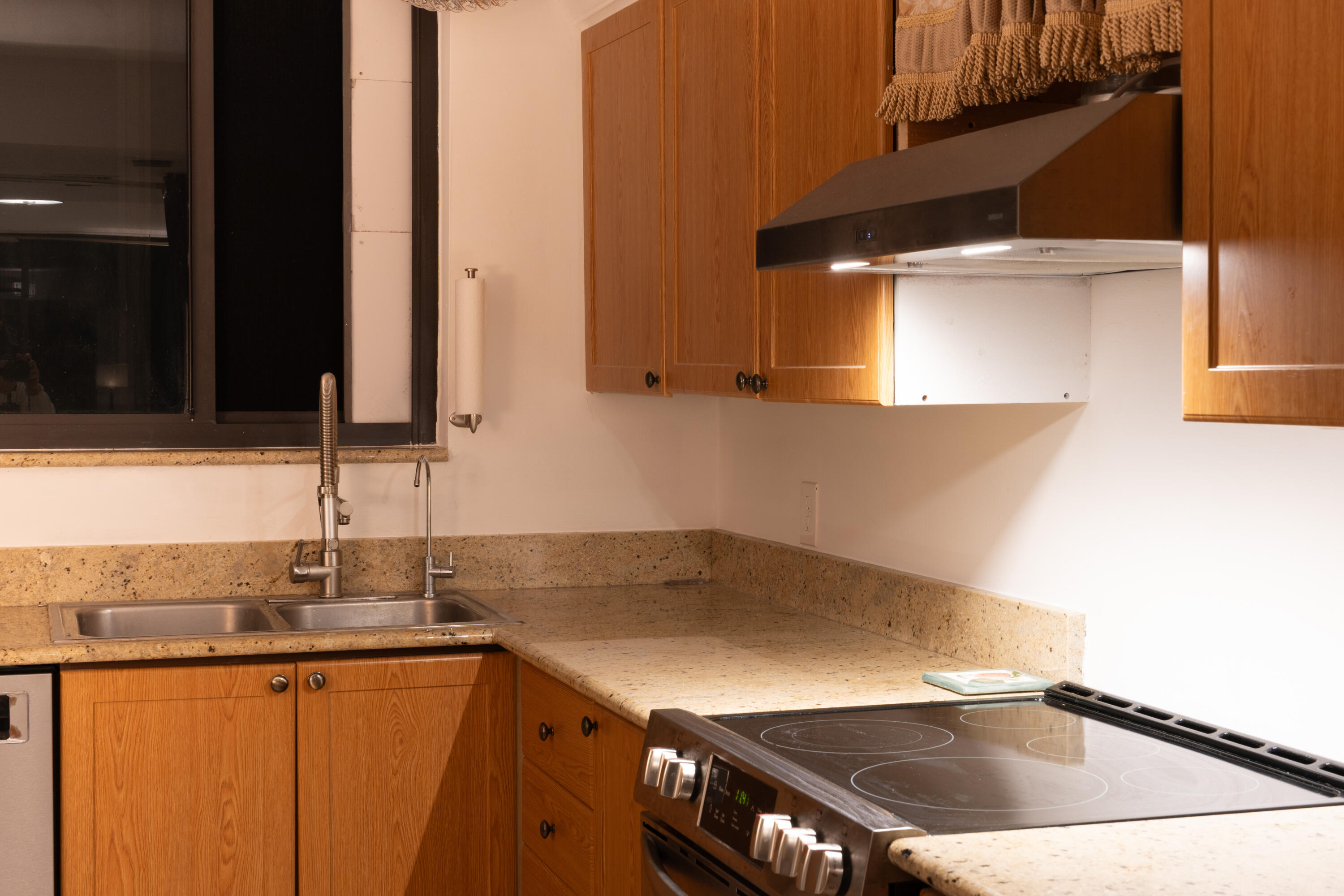 400 Ocean Trail Way, Unit 101 Jupiter, FL 33477 - Photo 59 of 60 a kitchen that has a sink and a stove