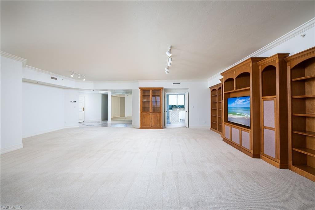 435 Dockside Drive, Unit B703 Naples, FL 34110 - Photo 6 of 38 a view of an empty room with a fireplace