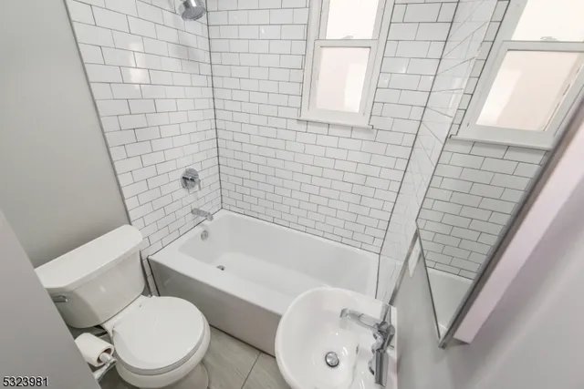 a white toilet sitting next to a bath tub and shower