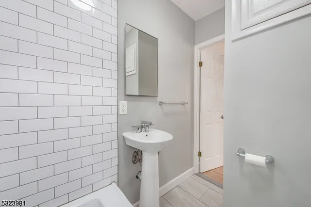 a bathroom with a sink a toilet and mirror