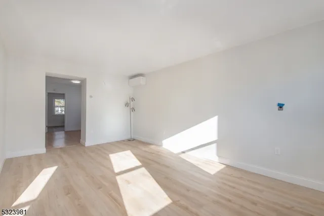a view of hallway with wooden floor