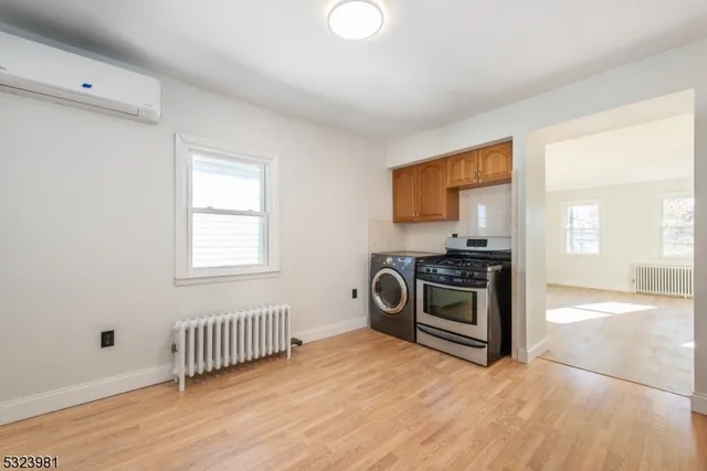 a view of a kitchen with a sink dishwasher and a fireplace