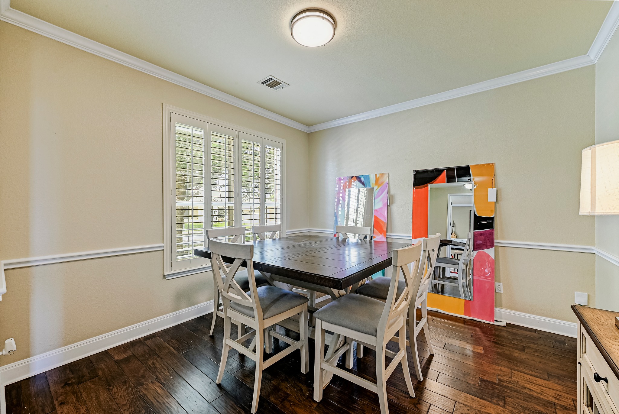 2408 Amen Corner Road Pflugerville, TX 78660 - Photo 7 of 40 Rich wood-finish flooring complements the crown molding and chair rail detailing