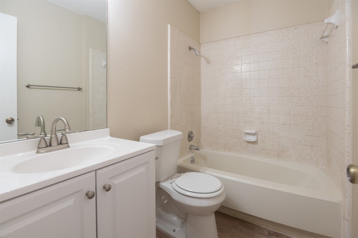 403 West Bowman Road, Unit A Round Rock, TX 78664 - Photo 13 of 17 a bathroom with a sink a toilet and shower