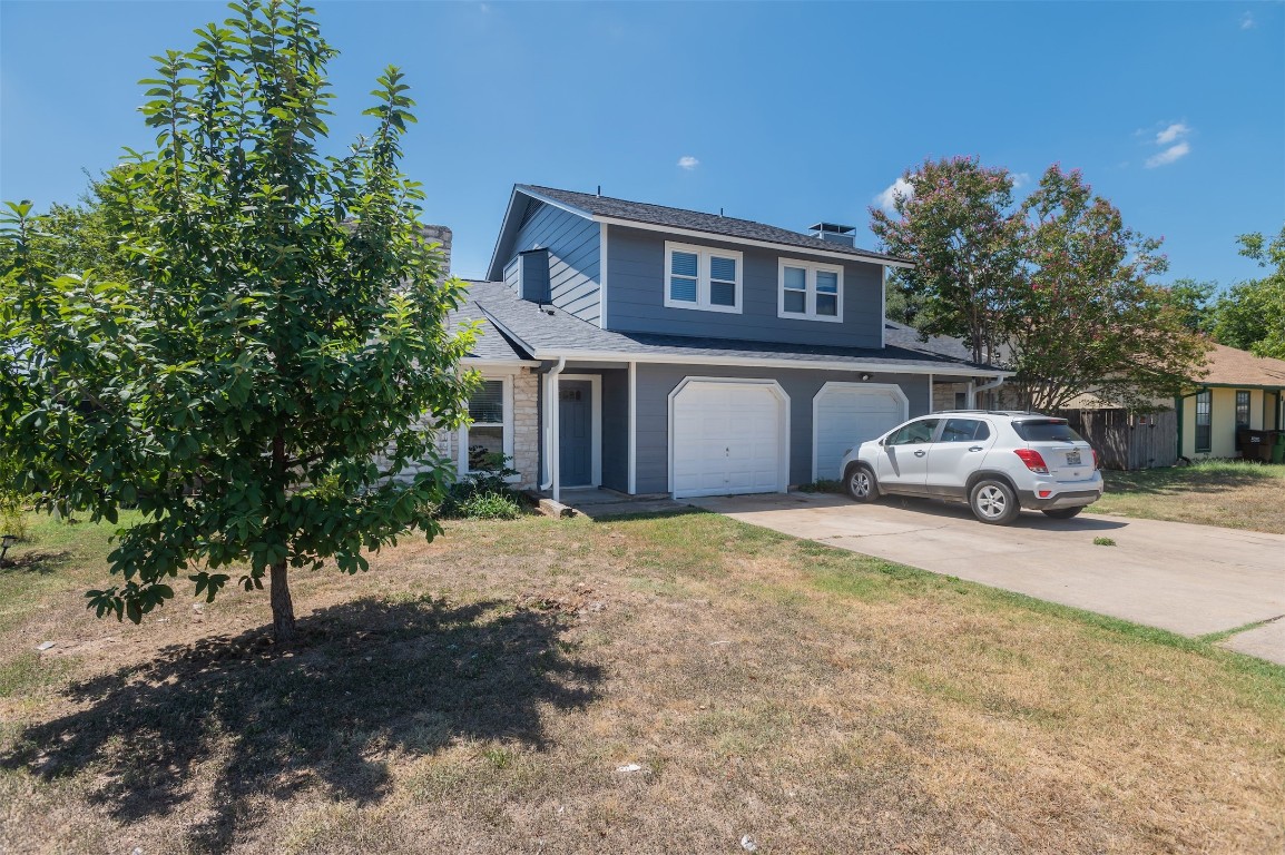 403 West Bowman Road, Unit A Round Rock, TX 78664 - Photo 2 of 17 a car parked in front of house with a trees