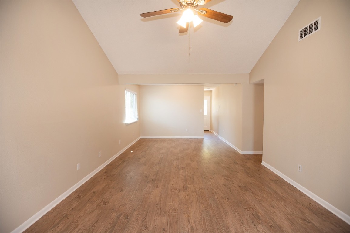 403 West Bowman Road, Unit A Round Rock, TX 78664 - Photo 5 of 17 an empty room with wooden floor and windows