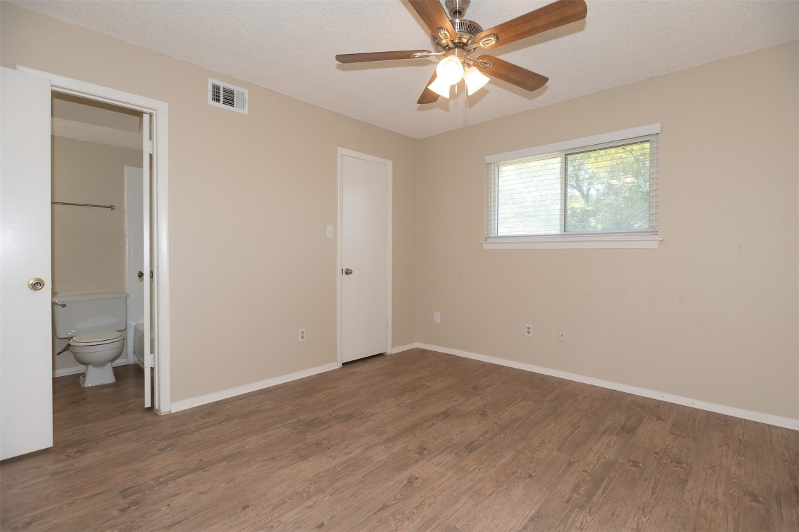 403 West Bowman Road, Unit A Round Rock, TX 78664 - Photo 9 of 17 wooden floor in an empty room with a window