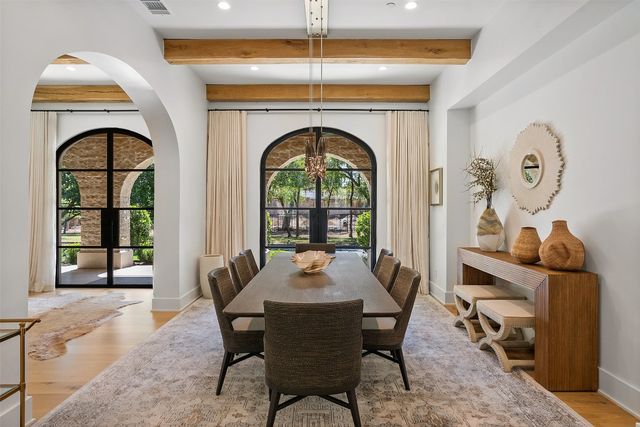 a dining room with a wooden table and chairs