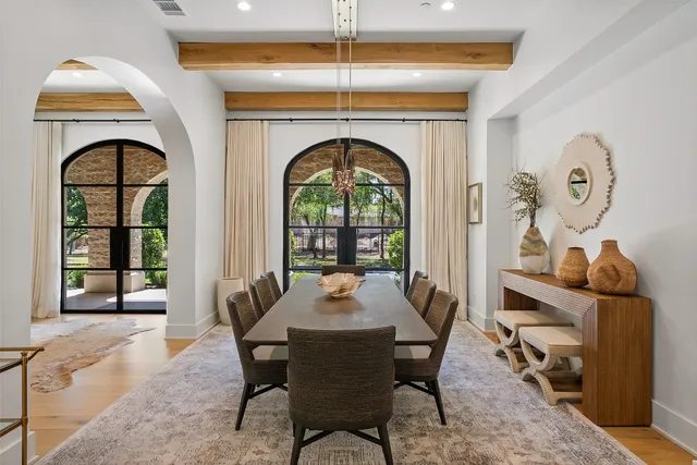 a dining room with a wooden table and chairs