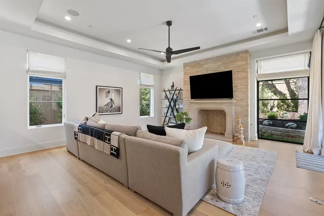 a living room with fireplace furniture and a flat screen tv