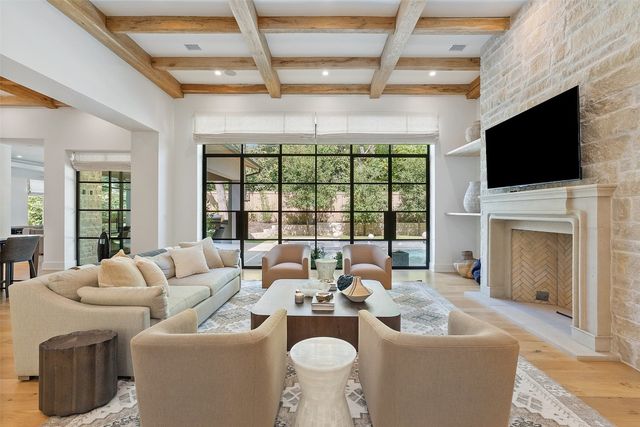 a living room with furniture a fireplace and a flat screen tv