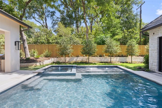 a view of swimming pool with a yard and sitting area