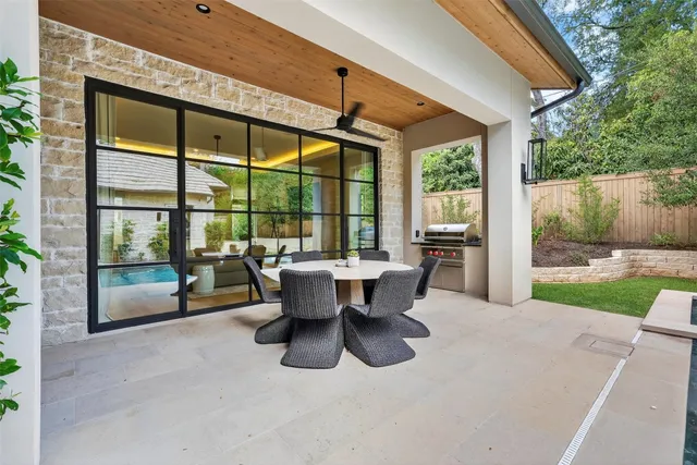 a view of a patio with a dining table and chairs