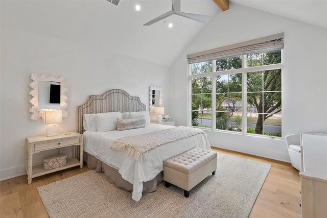 a bedroom with a bed chair and window