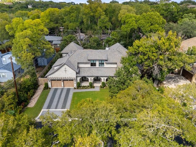an aerial view of a house with a yard basket ball court and outdoor seating
