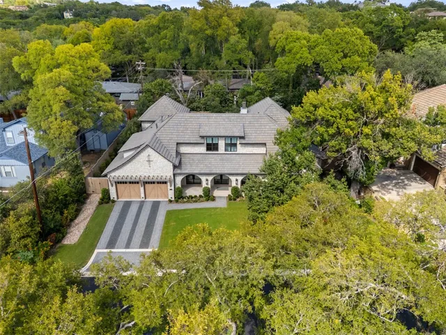 an aerial view of a house with a yard basket ball court and outdoor seating