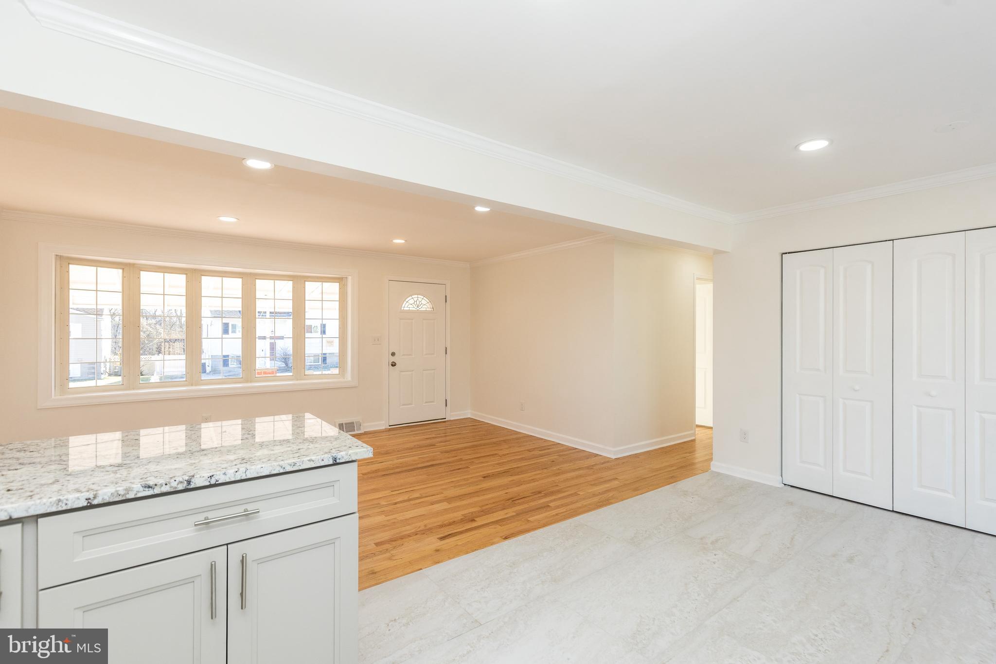 5510 Daybreak Terrace Baltimore, MD 21206 - Photo 13 of 43 a spacious bathroom with a granite countertop sink and a large mirror