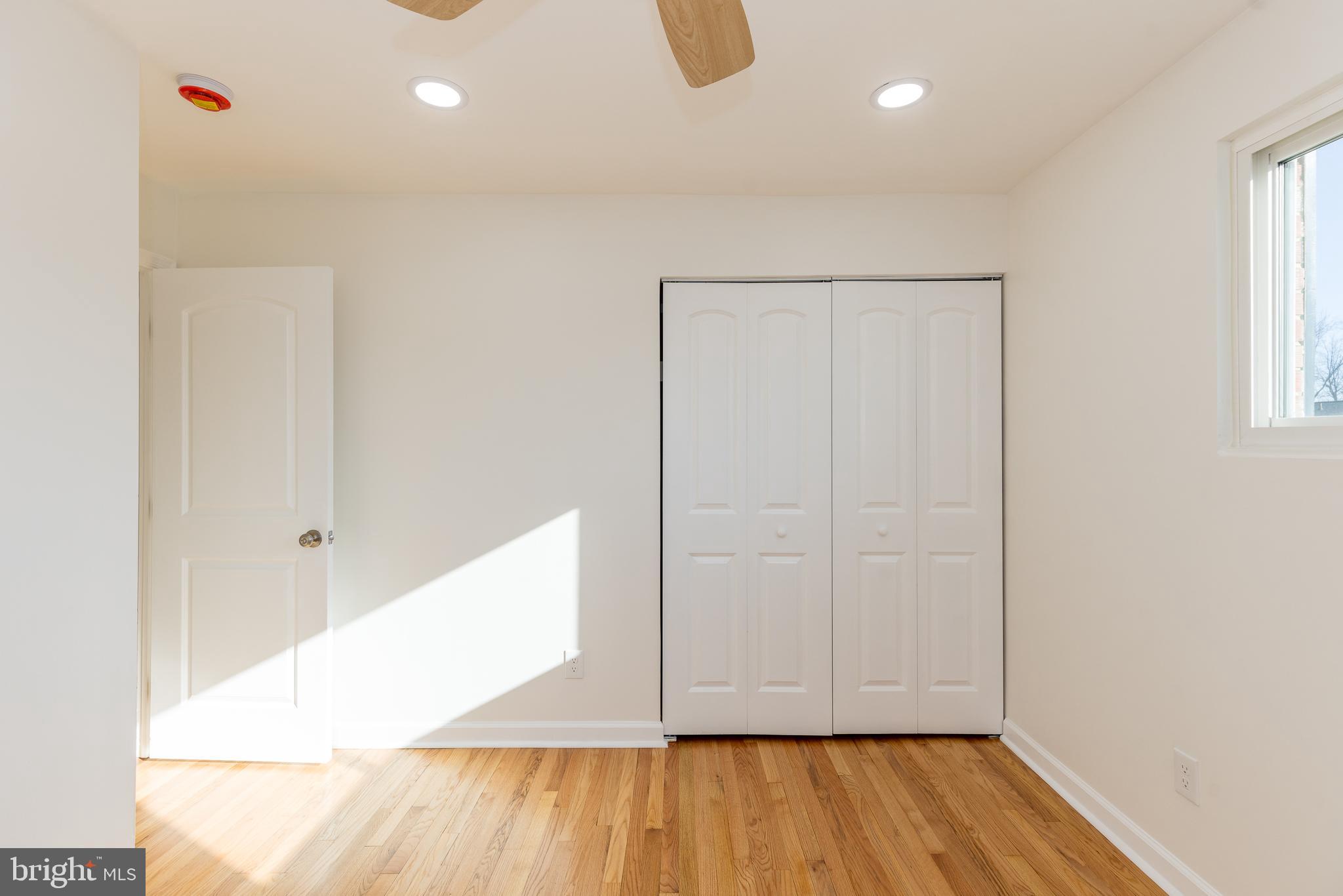 5510 Daybreak Terrace Baltimore, MD 21206 - Photo 22 of 43 an empty room with wooden floor and closet